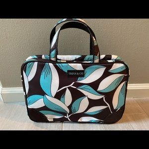 Beautiful brown, teal, and white cosmetic bag with 3 different compartments.